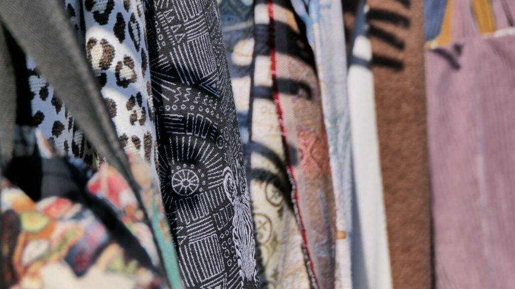 Vibrant close-up of diverse patterned fabrics hanging in Mayen, Germany.